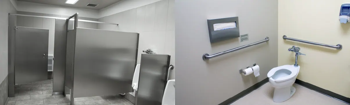 Commercial restroom with partitions, grab bars, and wall-mounted dispensers