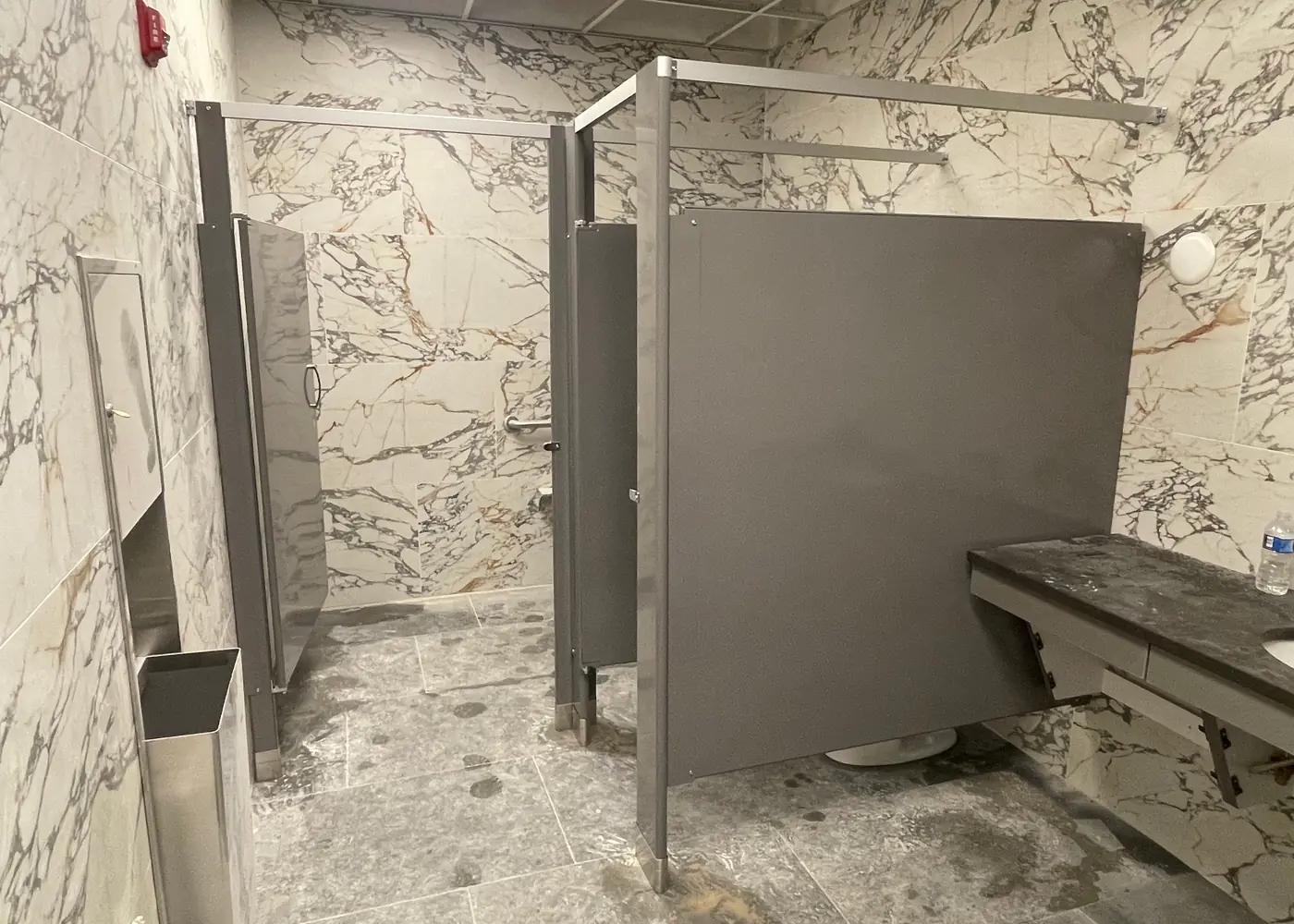 Toilet partition door and panels in a commercial restroom