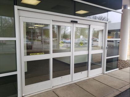 Automatic sliding glass entrance doors