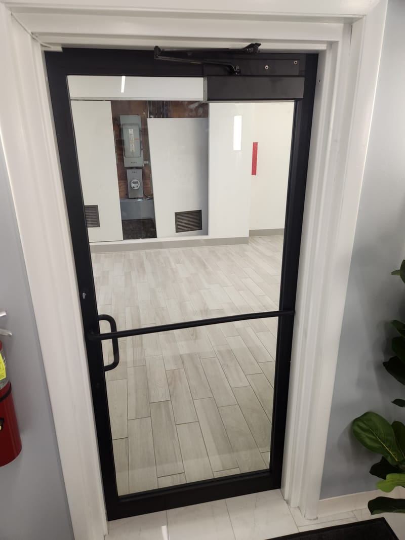 Black aluminum and glass door with a push bar and overhead closer - Cleveland, OH