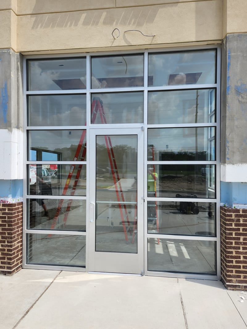 Tall clear anodized aluminum storefront entrance with sidelites and glazed transoms - Sandusky, OH