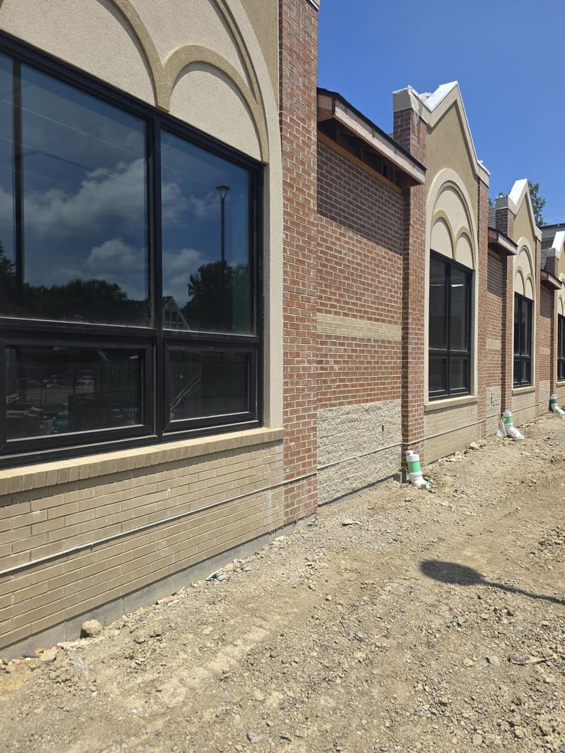 Dark bronze aluminum storefront windows along a brick building - Avon, OH
