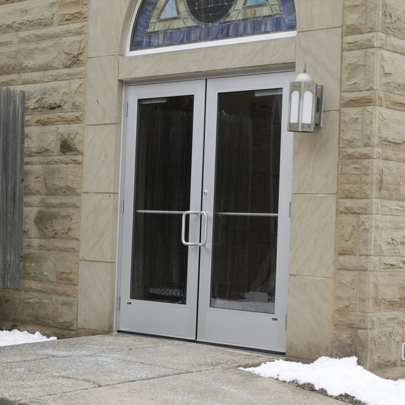 Glazed entrance doors beneath an arched transom - Sandusky, OH