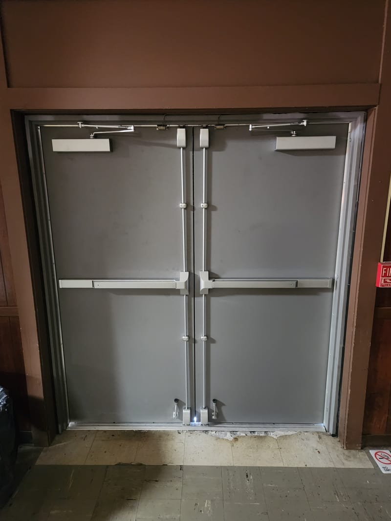 Hollow metal double doors with vertical rod exit devices and overhead closers - Oak Harbor, OH
