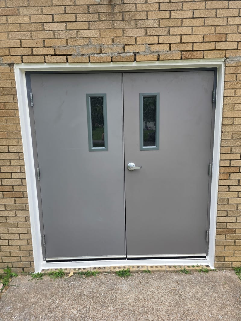 Exterior hollow metal double doors with narrow vision lites in a brick wall - Sandusky, OH