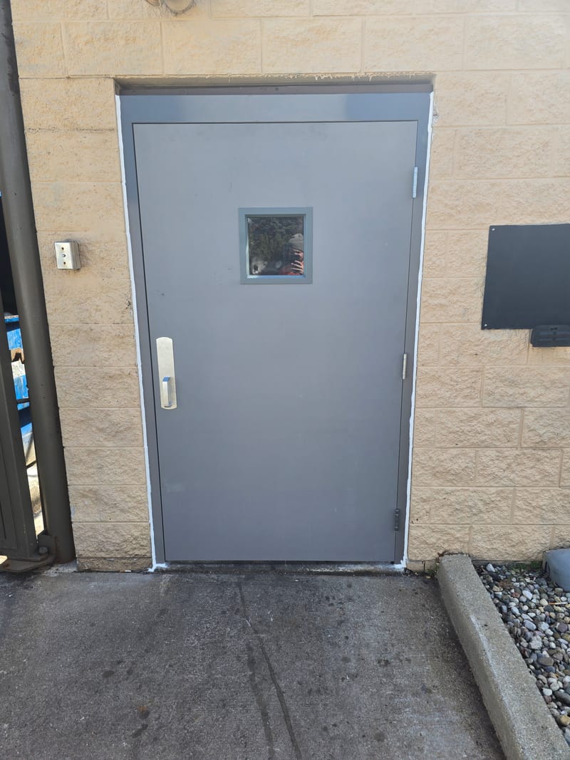 Exterior hollow metal door with a square vision lite and pull handle - Columbus, OH