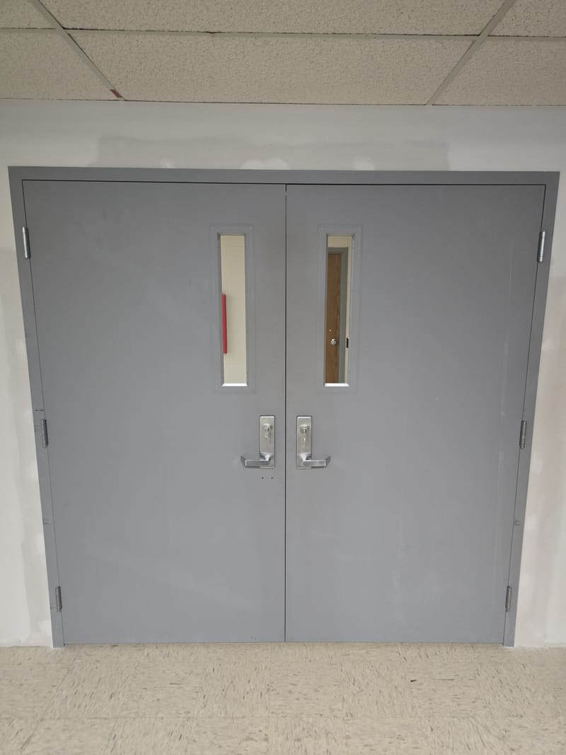 Interior hollow metal double doors with narrow vision lites and lever trim - Oberlin, OH