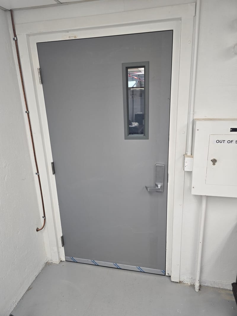 Hollow metal door with a narrow vision lite and commercial lever trim - Port Clinton, OH