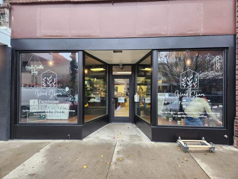 Dark bronze aluminum retail storefront with display windows and a recessed entrance - Sandusky, OH